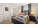 Inviting bedroom featuring dark wood furniture, decoratively coordinated linens, and a bright color palette at 2761 Honey Locust Court, Loganville, GA 30052