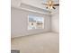 Well-lit bedroom features a ceiling fan and large window to promote a bright and welcoming atmosphere for relaxation at 2761 Honey Locust Court, Loganville, GA 30052