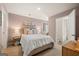 Tastefully designed bedroom featuring modern furnishings, decoratively styled linens, and ensuite bathroom at 2761 Honey Locust Court, Loganville, GA 30052