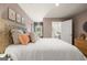 This comfortable bedroom features bright natural light and a convenient ensuite bath to create a relaxing retreat at 2761 Honey Locust Court, Loganville, GA 30052