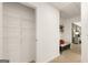 Walk-in closet with wire shelving offering ample storage solutions, adjoining hall with bench at 2761 Honey Locust Court, Loganville, GA 30052