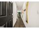 A hallway welcomes you with wood floors and a view of the living area and lots of natural light at 2761 Honey Locust Court, Loganville, GA 30052