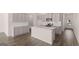 An open kitchen with white cabinets, stainless steel appliances and a central island offers a modern design at 2761 Honey Locust Court, Loganville, GA 30052