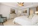 Well-lit primary bedroom with a sitting area, dresser, and a king-sized bed at 2761 Honey Locust Court, Loganville, GA 30052