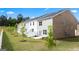 Backyard view of new construction townhomes with white picket fences and lush green lawns at 2761 Honey Locust Court, Loganville, GA 30052