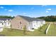 Backyard view of new construction townhomes with white picket fences and lush green lawns at 2761 Honey Locust Court, Loganville, GA 30052