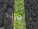 Aerial view showcasing the home's location on a wooded lot at 75 The Farm Rd, Mcdonough, GA 30252