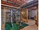 View of the unfinished basement featuring a home gym with weightlifting equipment at 75 The Farm Rd, Mcdonough, GA 30252