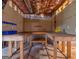 Unfinished basement with pegboard wall and large, wrap-around workbench at 75 The Farm Rd, Mcdonough, GA 30252