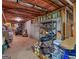Unfinished basement storage area with bins, boxes, and shelves at 75 The Farm Rd, Mcdonough, GA 30252