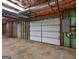 Unfinished basement with garage door, utility door, and electrical panel at 75 The Farm Rd, Mcdonough, GA 30252