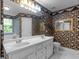 Bright bathroom featuring a double sink vanity, a large mirror and vibrant wallpaper, creating a unique and inviting space at 75 The Farm Rd, Mcdonough, GA 30252