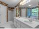 Bathroom features a double sink vanity, a large mirror, a shower and a soaking tub, creating a unique and inviting space at 75 The Farm Rd, Mcdonough, GA 30252