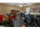 Cluttered bedroom with a ceiling fan, a window and moving boxes; ready to be transformed into a cozy retreat at 75 The Farm Rd, Mcdonough, GA 30252