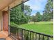 Relaxing covered front porch offering beautiful views of the lush, green front yard and trees at 75 The Farm Rd, Mcdonough, GA 30252