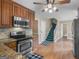Functional kitchen boasting stainless steel appliances, wooden cabinets, and access to a staircase at 75 The Farm Rd, Mcdonough, GA 30252