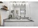 Bright bathroom featuring double sinks, granite countertops, and modern fixtures at 924 Bryson Lake Cir, Douglasville, GA 30134