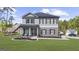 Charming two-story home featuring gray siding, brick accents, and a welcoming front porch with elegant columns at 924 Bryson Lake Cir, Douglasville, GA 30134