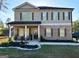 Charming home with covered front porch featuring brick and siding exterior, and well manicured lawn at 924 Bryson Lake Cir, Douglasville, GA 30134