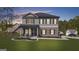 Charming two-story home featuring gray siding, brick accents, and a welcoming front porch with elegant columns at 924 Bryson Lake Cir, Douglasville, GA 30134