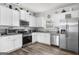 Bright kitchen featuring white cabinets, stainless steel appliances, and granite countertops at 924 Bryson Lake Cir, Douglasville, GA 30134