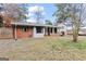 Exterior of home showing a partially fenced yard, with a covered patio, and mature trees at 3727 Calmer Cir, East Point, GA 30344