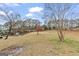 The back lawn slopes into a treeline, showing yard size and landscaping at 3727 Calmer Cir, East Point, GA 30344