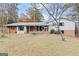 Backyard of home showing exterior elevation with patio, a partially fenced yard, and mature trees at 3727 Calmer Cir, East Point, GA 30344