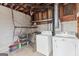 Unfinished basement featuring a utility sink, washer, dryer, concrete floors and exposed ductwork at 3727 Calmer Cir, East Point, GA 30344