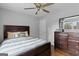 Well-lit bedroom featuring hardwood floors, a ceiling fan, and a dark wood dresser at 3727 Calmer Cir, East Point, GA 30344