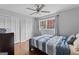 Cozy bedroom featuring a ceiling fan, hardwood floors, and multiple closets for ample storage at 3727 Calmer Cir, East Point, GA 30344