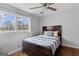 Comfortable bedroom featuring a ceiling fan, hardwood floors, and a large window at 3727 Calmer Cir, East Point, GA 30344