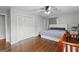 Bedroom featuring hardwood floors, ceiling fan, a bed, window with natural light and two closets at 3727 Calmer Cir, East Point, GA 30344