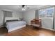 Bedroom featuring hardwood floors, ceiling fan, a bed, window with natural light and a crib at 3727 Calmer Cir, East Point, GA 30344