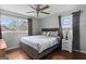 Inviting bedroom featuring wood floors, large windows, and a ceiling fan for added comfort at 3727 Calmer Cir, East Point, GA 30344