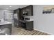 Modern kitchen featuring stainless steel appliances and dark cabinets against gray walls and wood floors at 3727 Calmer Cir, East Point, GA 30344