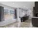 Bright kitchen featuring gray walls, wood floors, ample natural light from two windows, and dark cabinets at 3727 Calmer Cir, East Point, GA 30344