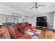 Spacious living room with hardwood floors, modern ceiling fans and an open concept to dining area at 3727 Calmer Cir, East Point, GA 30344