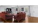 Inviting living room with hardwood floors, a modern ceiling fan, and bright windows offering natural light at 3727 Calmer Cir, East Point, GA 30344