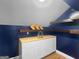 Finished attic space with wood flooring, blue walls, and built-in shelving at 100 Little Creek Dr, Sharpsburg, GA 30277