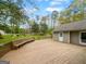 Spacious wooden deck with built-in bench seating and views of the expansive backyard, great for outdoor entertaining at 100 Little Creek Dr, Sharpsburg, GA 30277