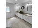 Bright bathroom with double sinks, neutral countertops and tiled floors at 100 Little Creek Dr, Sharpsburg, GA 30277