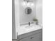 Bathroom sink with updated light fixture, vanity, quartz countertop, matte black faucet, and round mirror at 100 Little Creek Dr, Sharpsburg, GA 30277