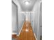 Hallway with hardwood floors and a series of white doors at 100 Little Creek Dr, Sharpsburg, GA 30277