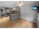 Open concept kitchen and dining area featuring hardwood floors and stainless steel appliances at 100 Little Creek Dr, Sharpsburg, GA 30277