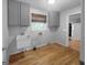 A practical laundry room featuring hardwood floors, a utility sink, and ample space at 100 Little Creek Dr, Sharpsburg, GA 30277