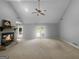 Spacious living room featuring vaulted ceilings, a ceiling fan, stone fireplace, and access to an outdoor deck at 100 Little Creek Dr, Sharpsburg, GA 30277
