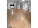 Open concept living room with durable wood flooring, fresh paint, and new baseboards at 100 Little Creek Dr, Sharpsburg, GA 30277
