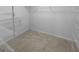 A walk-in closet with carpeted floors and metal shelving ready for storage and organization at 100 Little Creek Dr, Sharpsburg, GA 30277