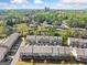 An aerial view showcases a sprawling townhome community with lush greenery and a cityscape backdrop at 1341 Rosen Rd, Brookhaven, GA 30319